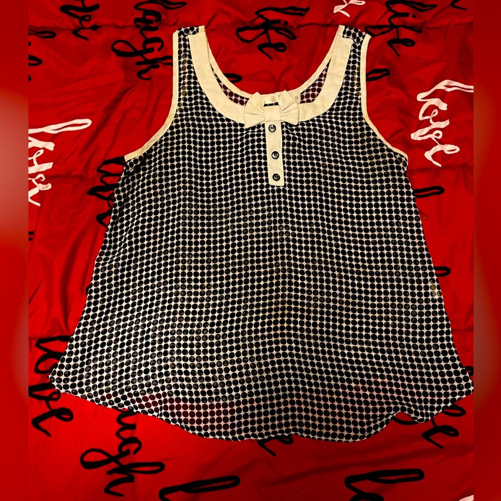 Black and white polka dot sheer shirt with decorative small bow. Size medium